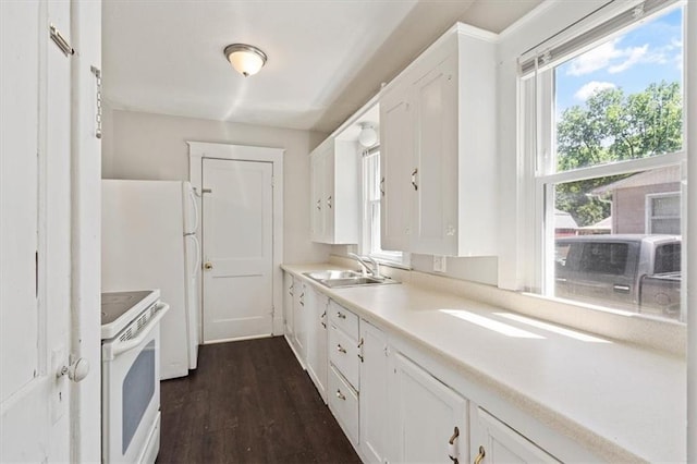 11412 E 20th St S, Independence, MO 64052 - kitchen with white appliances, a sink, white cabinets, and dark wood-style flooring