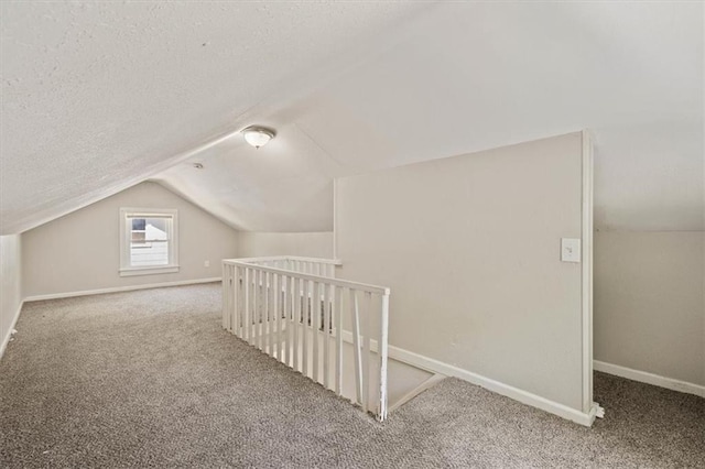 11412 E 20th St S, Independence, MO 64052 - bonus room featuring lofted ceiling, carpet floors, baseboards, and a textured ceiling