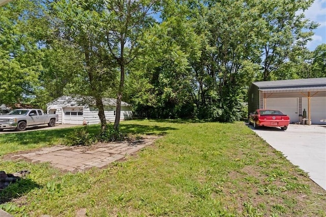 11412 E 20th St S, Independence, MO 64052 - view of green lawn with a detached garage and an outbuilding