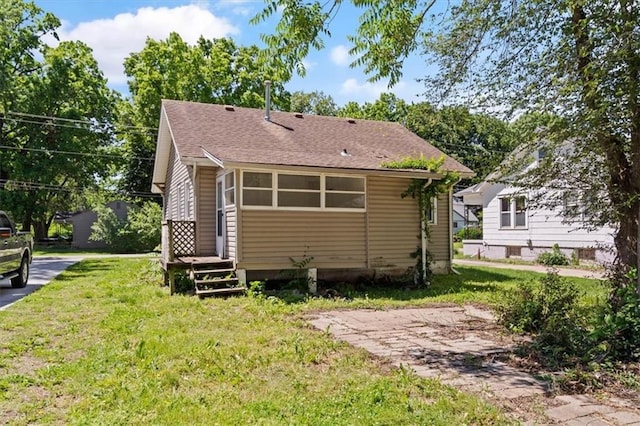 11412 E 20th St S, Independence, MO 64052 - rear view of property with a yard and a shingled roof