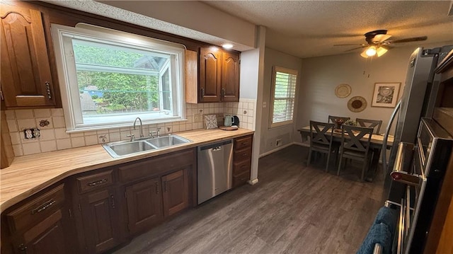 12909 E 40th St S, Independence, MO 64055 - kitchen with dishwasher, a sink, dark wood finished floors, decorative backsplash, and ceiling fan