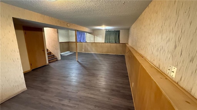 12909 E 40th St S, Independence, MO 64055 - finished basement featuring a textured ceiling, dark wood finished floors, and stairs