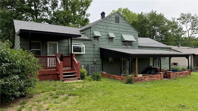 12909 E 40th St S, Independence, MO 64055 - back of house with roof with shingles, a lawn, a chimney, and central AC unit