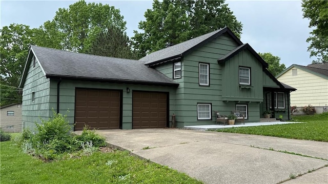 12909 E 40th St S, Independence, MO 64055 - view of front of house with roof with shingles, an attached garage, a front yard, and driveway