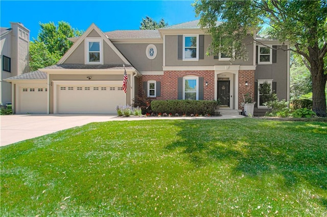 13125 Sherwood St, Leawood, KS 66209 - view of front facade featuring stucco siding, an attached garage, driveway, a front yard, and brick siding