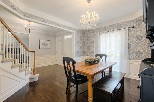13125 Sherwood St, Leawood, KS 66209 - dining area with a chandelier, dark wood finished floors, crown molding, wainscoting, and stairs