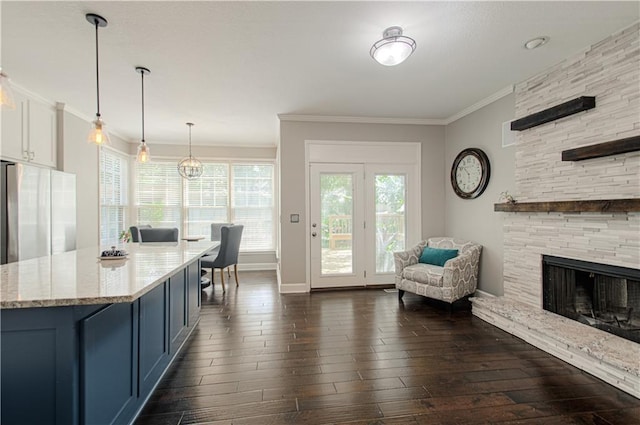13125 Sherwood St, Leawood, KS 66209 - kitchen featuring dark wood finished floors, healthy amount of natural light, light stone counters, and ornamental molding