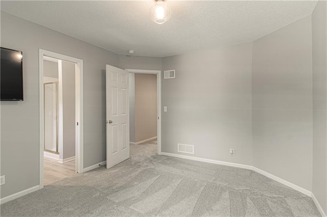 13125 Sherwood St, Leawood, KS 66209 - unfurnished bedroom featuring carpet and a textured ceiling