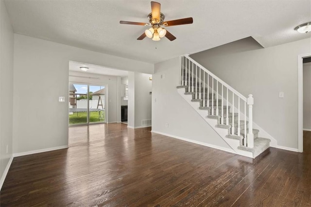 10118 E 220th St, Peculiar, MO 64078 - unfurnished living room featuring wood finished floors, stairway, a ceiling fan, baseboards, and a textured ceiling