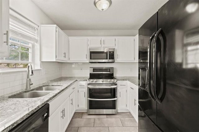 10118 E 220th St, Peculiar, MO 64078 - kitchen featuring black appliances, a sink, light stone counters, and white cabinetry