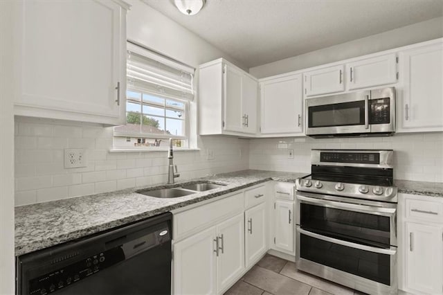 10118 E 220th St, Peculiar, MO 64078 - kitchen with appliances with stainless steel finishes, a sink, and white cabinets