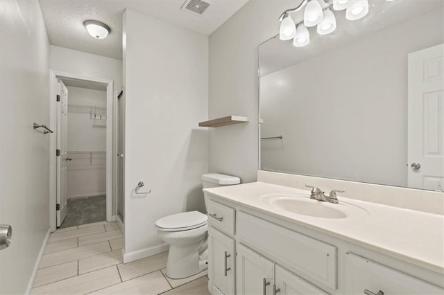 10118 E 220th St, Peculiar, MO 64078 - bathroom with vanity, toilet, a walk in closet, and baseboards