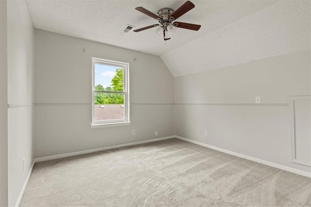 10118 E 220th St, Peculiar, MO 64078 - additional living space with carpet, ceiling fan, a textured ceiling, vaulted ceiling, and baseboards