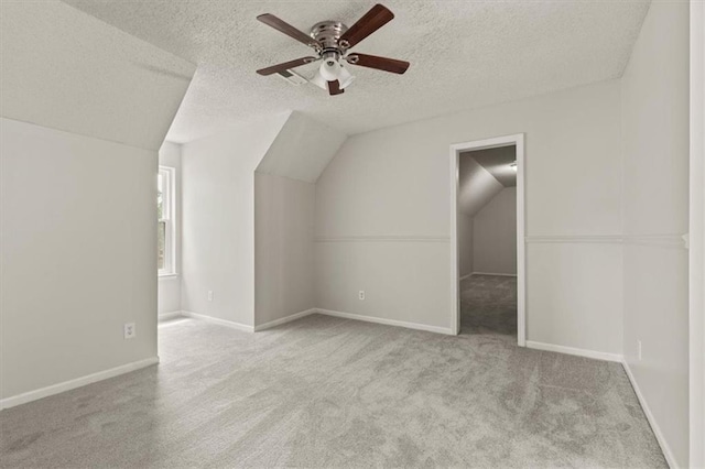 10118 E 220th St, Peculiar, MO 64078 - bonus room with vaulted ceiling, carpet, ceiling fan, a textured ceiling, and baseboards