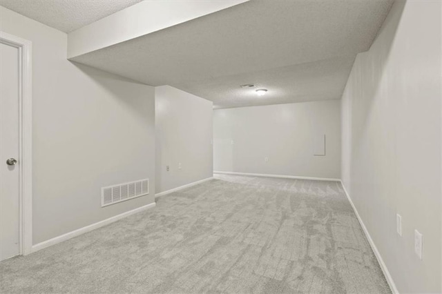 10118 E 220th St, Peculiar, MO 64078 - finished basement with a textured ceiling, carpet flooring, and baseboards