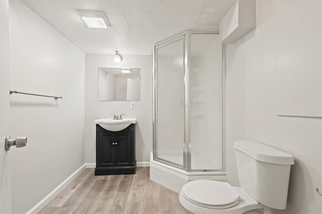 10118 E 220th St, Peculiar, MO 64078 - full bathroom featuring toilet, vanity, a shower stall, wood finished floors, and baseboards