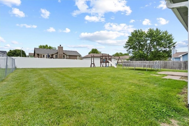 10118 E 220th St, Peculiar, MO 64078 - view of yard featuring a playground and a trampoline