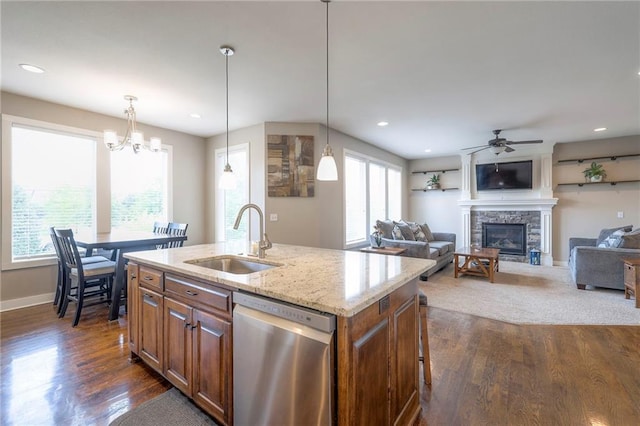 17304 S Schweiger Dr, Olathe, KS 66062 - kitchen with stainless steel dishwasher, a sink, brown cabinets, a fireplace, and recessed lighting