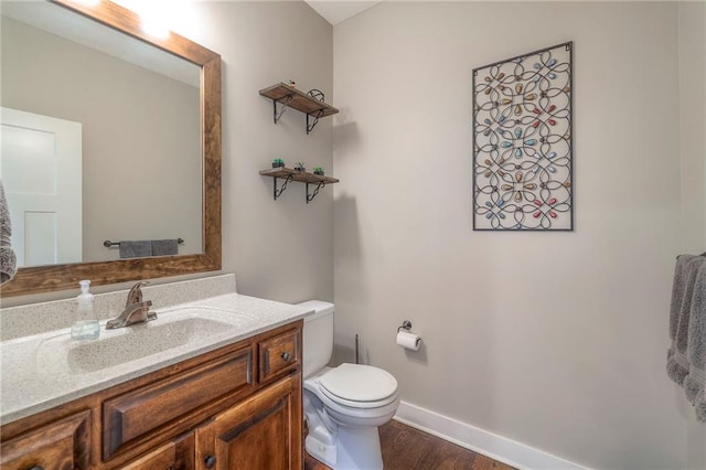 17304 S Schweiger Dr, Olathe, KS 66062 - half bath featuring toilet, vanity, baseboards, and wood finished floors
