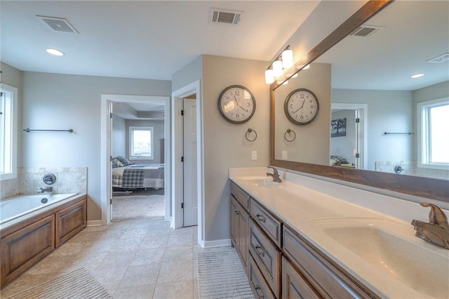17304 S Schweiger Dr, Olathe, KS 66062 - bathroom with double vanity, a bath, baseboards, tile patterned flooring, and ensuite bath