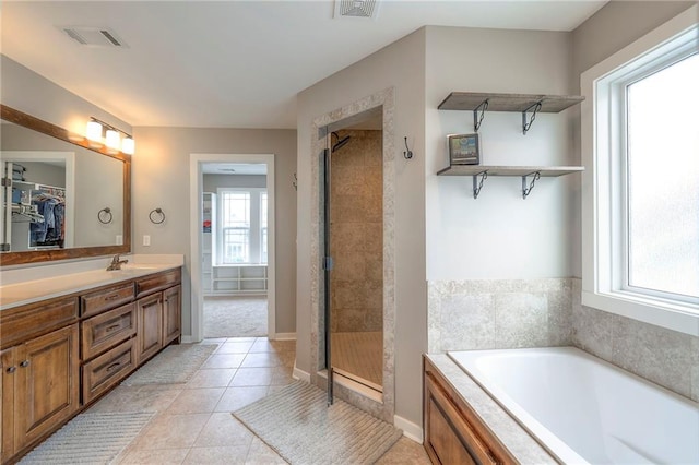 17304 S Schweiger Dr, Olathe, KS 66062 - full bath featuring a bath, a stall shower, double vanity, a walk in closet, and tile patterned floors
