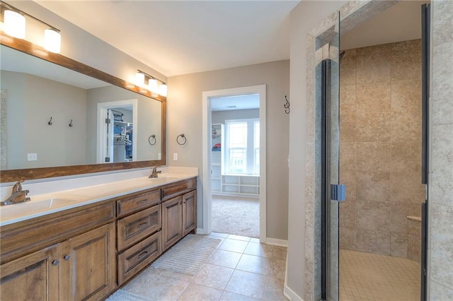 17304 S Schweiger Dr, Olathe, KS 66062 - full bath featuring a spacious closet, double vanity, a stall shower, tile patterned flooring, and baseboards