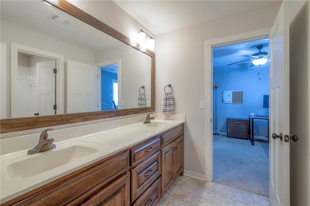 17304 S Schweiger Dr, Olathe, KS 66062 - full bath with double vanity, ceiling fan, baseboards, and tile patterned floors