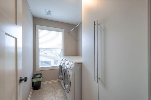 17304 S Schweiger Dr, Olathe, KS 66062 - laundry area with washer and clothes dryer, baseboards, and light tile patterned flooring
