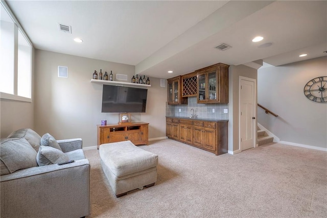 17304 S Schweiger Dr, Olathe, KS 66062 - living area featuring bar with sink, recessed lighting, light carpet, stairway, and baseboards