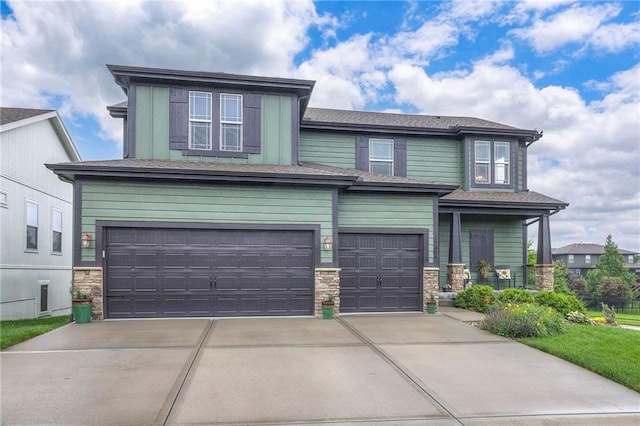 17304 S Schweiger Dr, Olathe, KS 66062 - view of front of property with a garage, stone siding, and concrete driveway