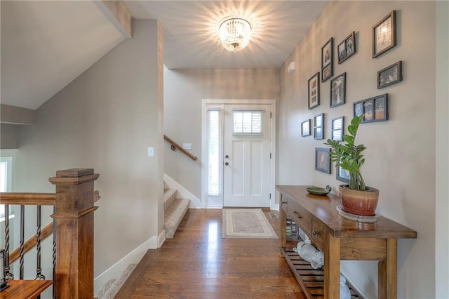 17304 S Schweiger Dr, Olathe, KS 66062 - foyer entrance featuring wood finished floors, stairs, lofted ceiling, baseboards, and a chandelier
