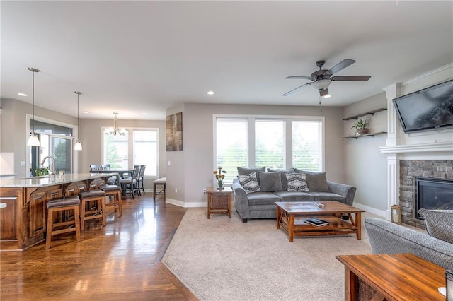 17304 S Schweiger Dr, Olathe, KS 66062 - living area featuring recessed lighting, baseboards, wood finished floors, a ceiling fan, and a fireplace