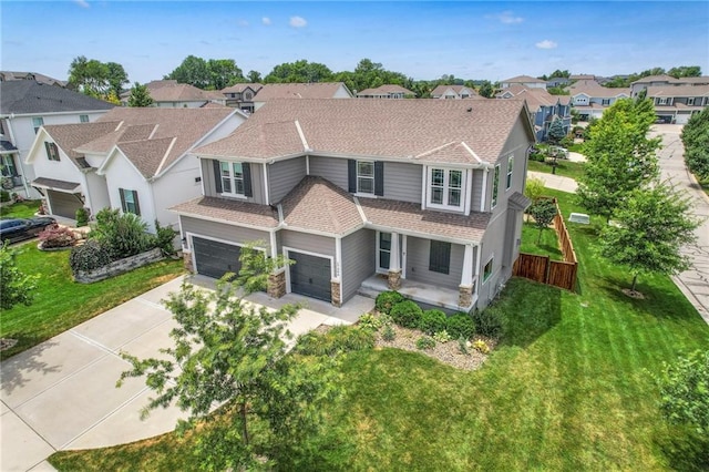 17304 S Schweiger Dr, Olathe, KS 66062 - view of front facade with a residential view, concrete driveway, a front yard, and roof with shingles