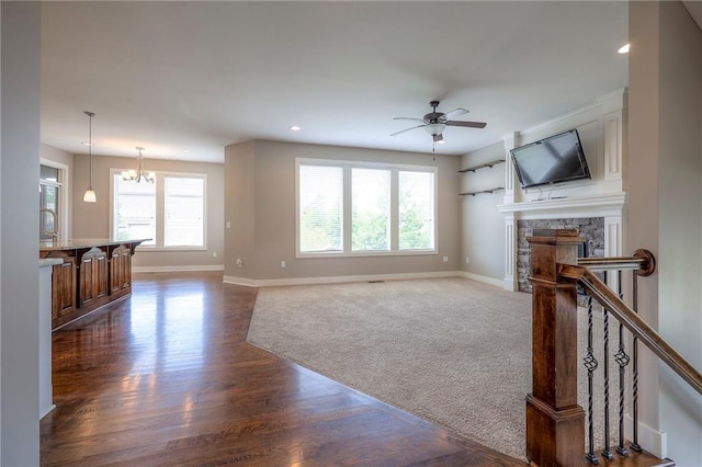 17304 S Schweiger Dr, Olathe, KS 66062 - living area with ceiling fan, dark wood-style flooring, a fireplace, recessed lighting, and a chandelier