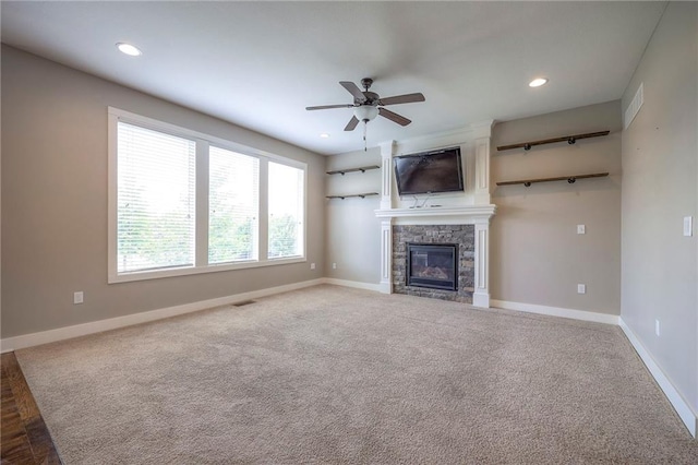 17304 S Schweiger Dr, Olathe, KS 66062 - unfurnished living room with a stone fireplace, a ceiling fan, recessed lighting, and carpet flooring