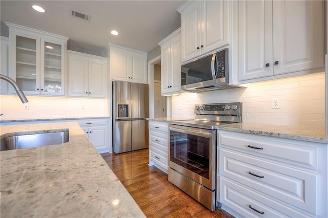 17304 S Schweiger Dr, Olathe, KS 66062 - kitchen featuring stainless steel appliances, white cabinets, glass insert cabinets, backsplash, and light stone counters