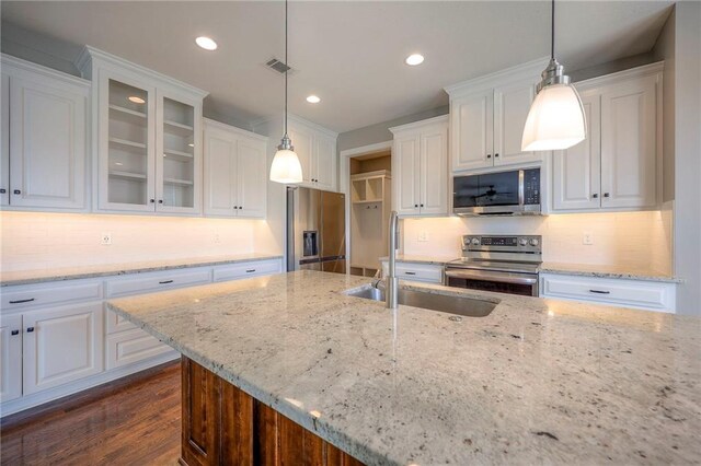17304 S Schweiger Dr, Olathe, KS 66062 - kitchen with stainless steel appliances, white cabinets, glass insert cabinets, backsplash, and recessed lighting