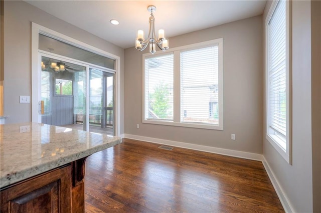 17304 S Schweiger Dr, Olathe, KS 66062 - unfurnished dining area featuring a chandelier, plenty of natural light, and dark wood-type flooring