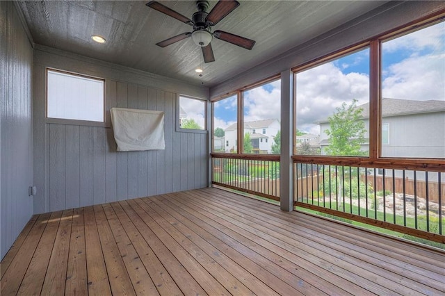 17304 S Schweiger Dr, Olathe, KS 66062 - unfurnished sunroom featuring ceiling fan, hardwood / wood-style floors, a deck, and wooden walls