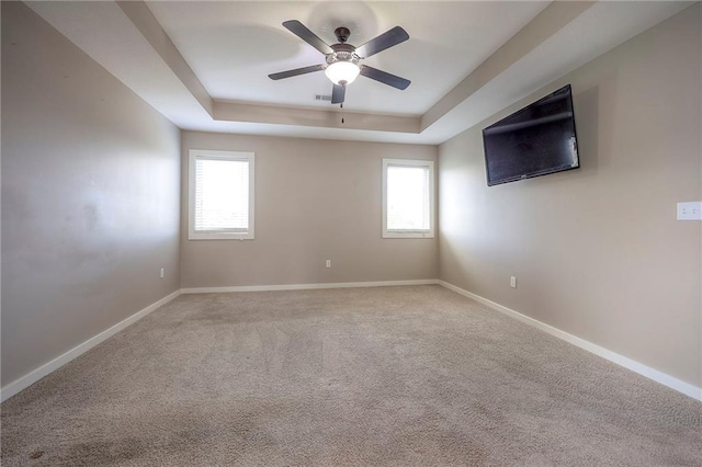 17304 S Schweiger Dr, Olathe, KS 66062 - unfurnished room featuring a raised ceiling, plenty of natural light, a ceiling fan, and carpet floors