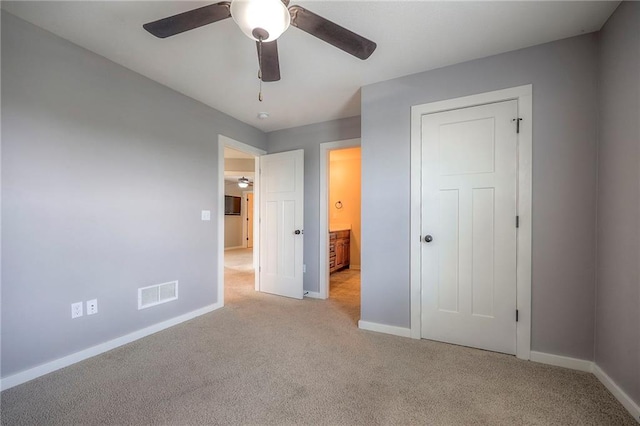 17304 S Schweiger Dr, Olathe, KS 66062 - unfurnished bedroom with light colored carpet, ceiling fan, and connected bathroom