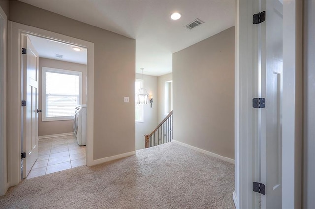17304 S Schweiger Dr, Olathe, KS 66062 - hall with light colored carpet, washer / dryer, an upstairs landing, light tile patterned floors, and recessed lighting