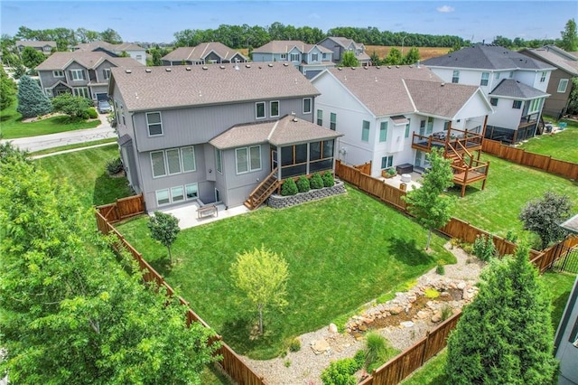 17304 S Schweiger Dr, Olathe, KS 66062 - rear view of property featuring roof with shingles, a residential view, a sunroom, and a patio area
