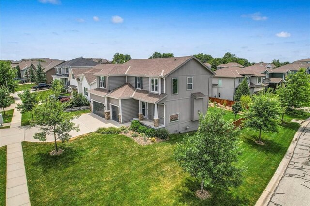17304 S Schweiger Dr, Olathe, KS 66062 - back of house featuring a residential view, driveway, a yard, a garage, and roof with shingles