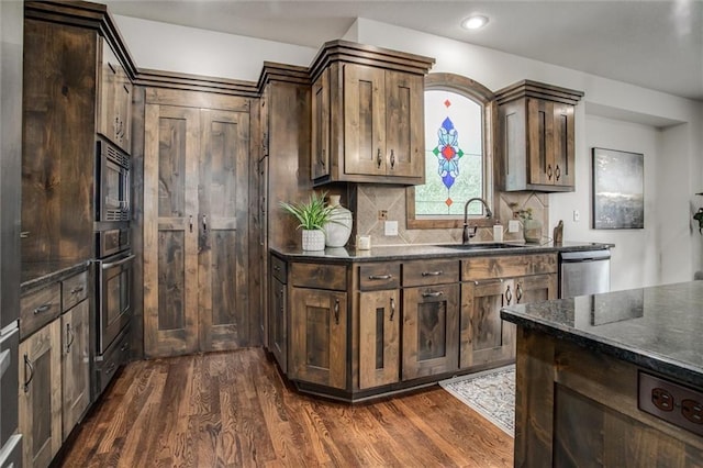 17224 Haskins St, Overland Park, KS 66062 - kitchen featuring stainless steel appliances, dark wood-style flooring, dark brown cabinetry, tasteful backsplash, and recessed lighting