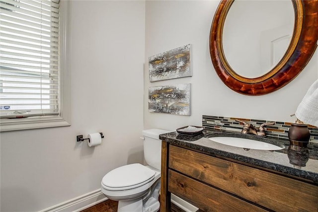 17224 Haskins St, Overland Park, KS 66062 - half bath featuring vanity, backsplash, a baseboard heating unit, and wood finished floors