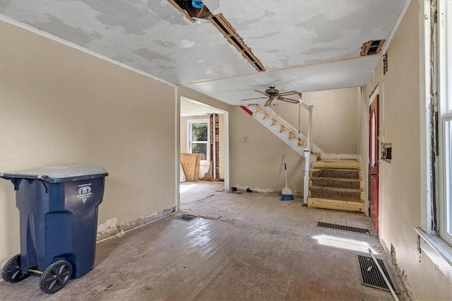 2921 E 54th St, Kansas City, MO 64130 - unfurnished living room featuring stairs and ceiling fan