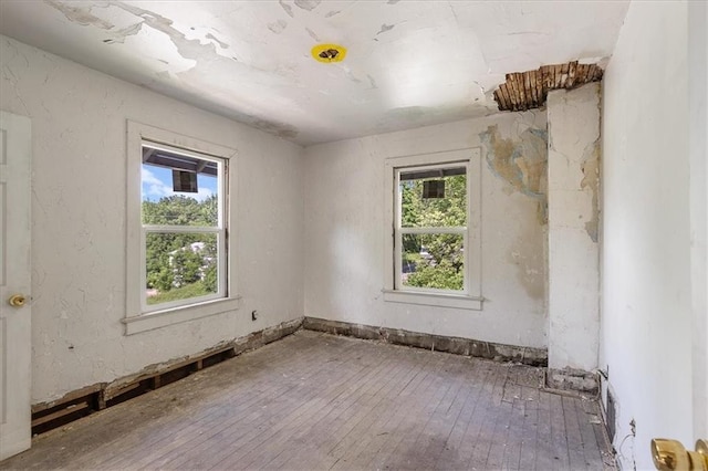 2921 E 54th St, Kansas City, MO 64130 - unfurnished room with hardwood / wood-style flooring and healthy amount of natural light