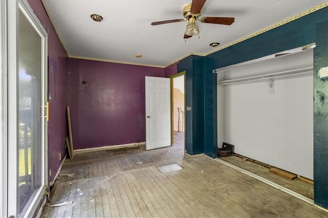 2921 E 54th St, Kansas City, MO 64130 - unfurnished bedroom featuring hardwood / wood-style flooring, a closet, a ceiling fan, and baseboards