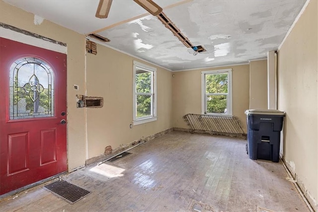 2921 E 54th St, Kansas City, MO 64130 - entrance foyer with healthy amount of natural light, wood-type flooring, and crown molding